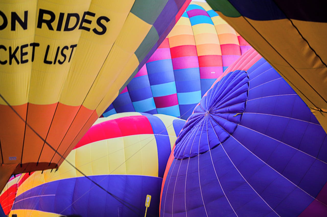 Vibrant hot air balloons inflating at a balloon fiesta in New Mexico.